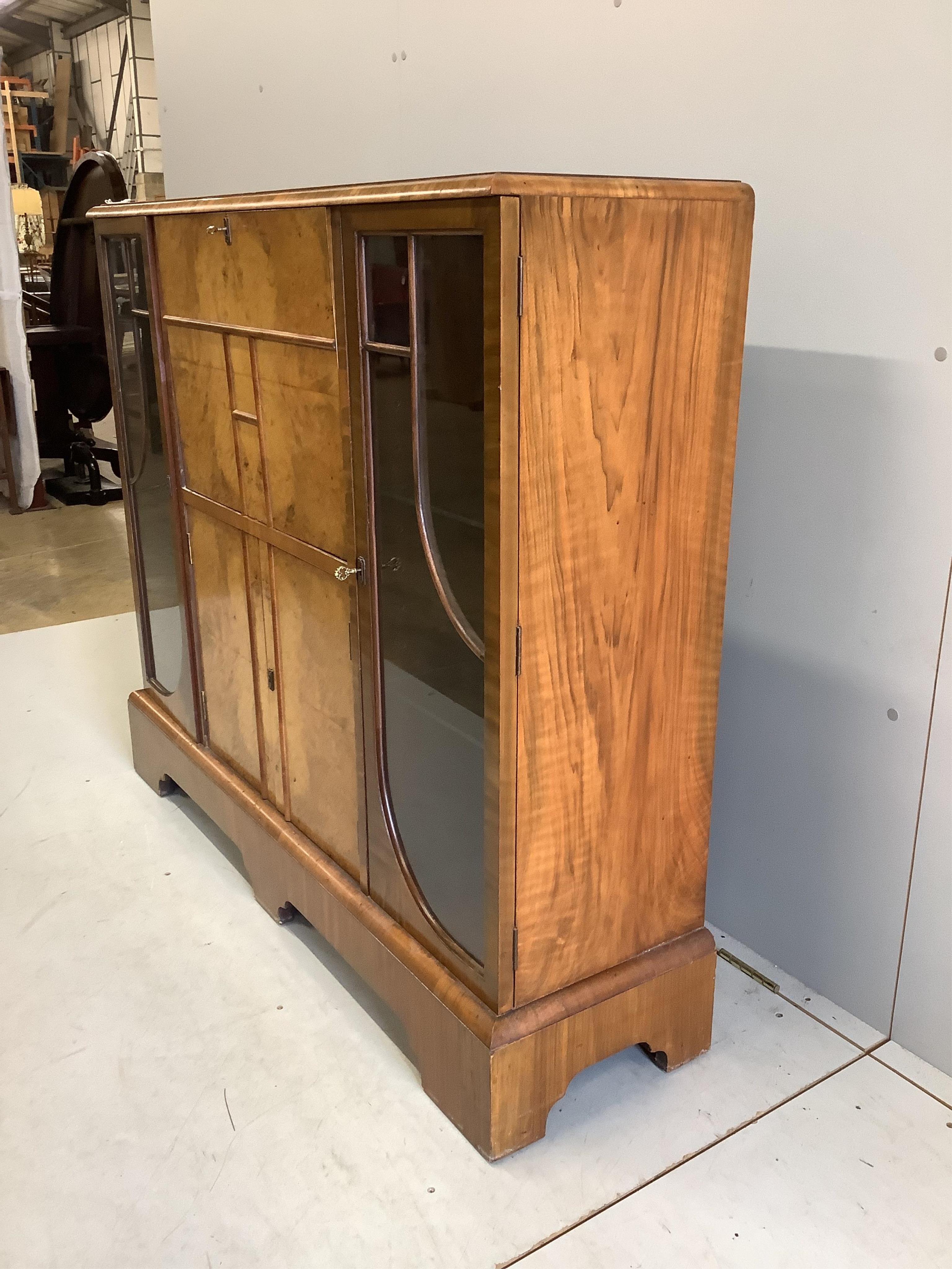 An early 20th century Art Deco style burr walnut secretaire cabinet, width 122cm, depth 34cm, height 107cm. Condition - fair to good